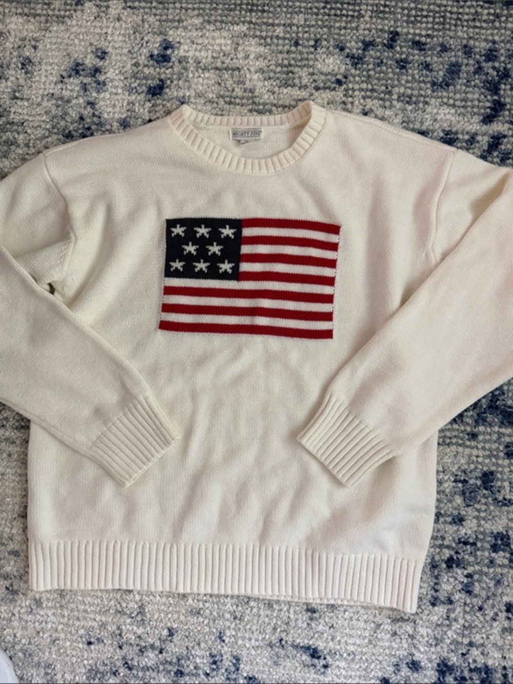 Mighty Fine American flag knit pullover sweater featuring a ribbed collar.
